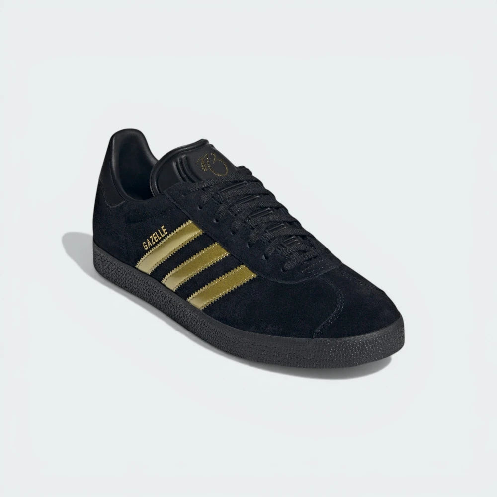 Emphasising the T-toe overlay and the striking gold-on-black premium aesthetic.