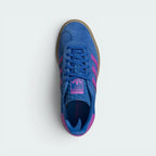 Focuses on the tidy lace closure, the clean alignment of the textured blue tongue, and the iconic T-toe configuration covering the front box.