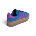 Focuses on the contoured shape of the purple leather heel tab and the distinct, clean alignment of the triple-layered sole seams.