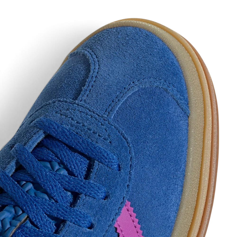 Details the premium stitching lines across the soft blue suede toe cap and the precision lace eyelet layout.