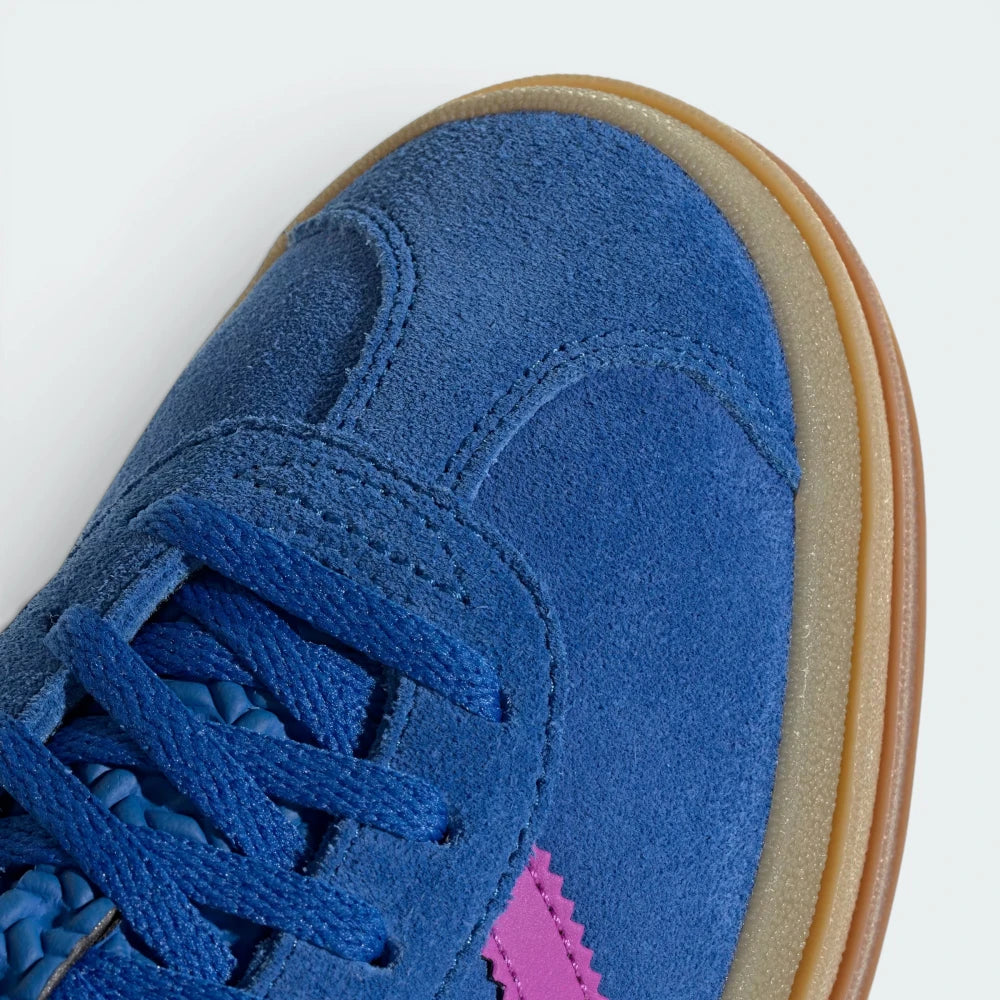 Details the premium stitching lines across the soft blue suede toe cap and the precision lace eyelet layout.