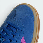 Details the premium stitching lines across the soft blue suede toe cap and the precision lace eyelet layout.