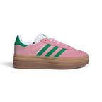 Side Profile Image: Studio lateral shot of the adidas Gazelle Bold in True Pink and Green, highlighting the soft pink suede upper, green serrated three stripes, gold foil Gazelle branding, and the triple-stacked gum rubber platform midsole.   