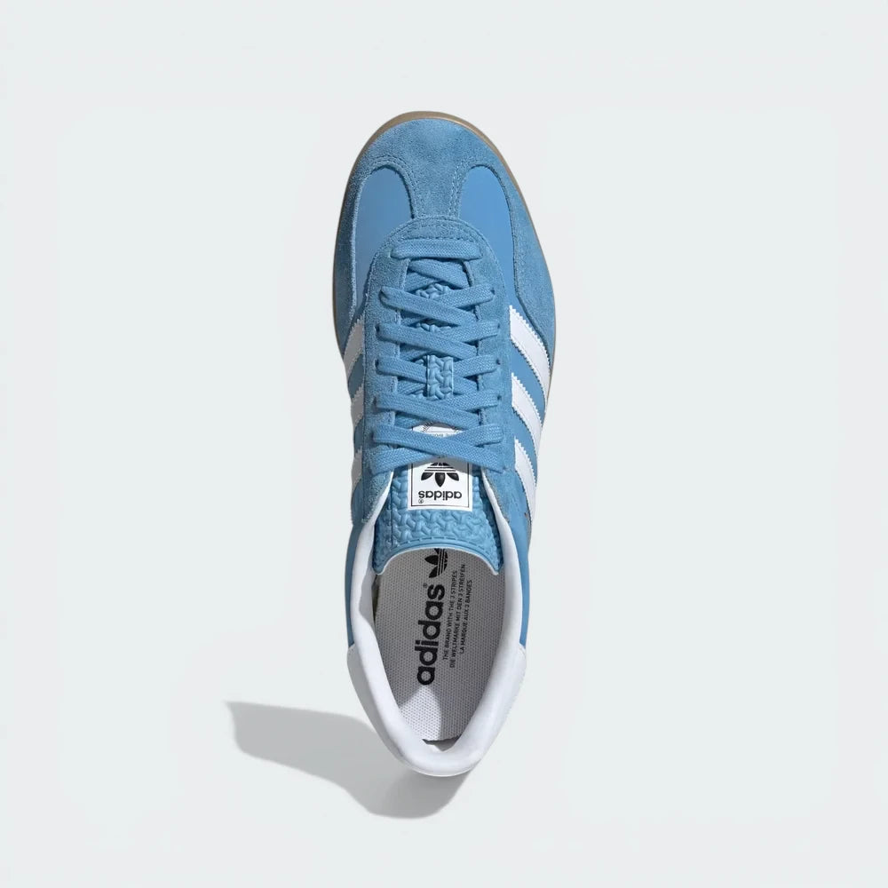Top-Down View of Pair: Looking down at the light blue suede lacing system and the textured tongue branding.