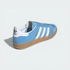 Focusing on the Cloud White heel tab and the unique wrap-around design of the gum sole.