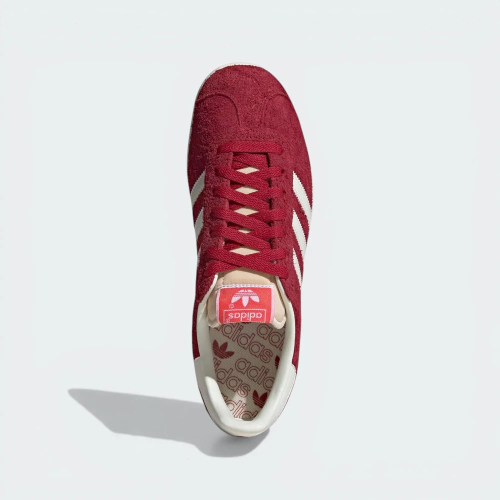 Looking down at the red suede lacing system and the tonal branding on the tongue.