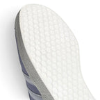 Macro view of the lateral midfoot perimeter, highlighting the textured rubber cupsole sidewalls, debossed sole wrap, and clean edge stitching along the white serrated 3-Stripes.