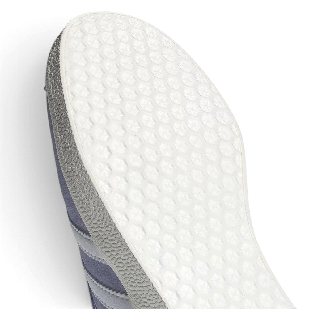 Macro view of the lateral midfoot perimeter, highlighting the textured rubber cupsole sidewalls, debossed sole wrap, and clean edge stitching along the white serrated 3-Stripes.