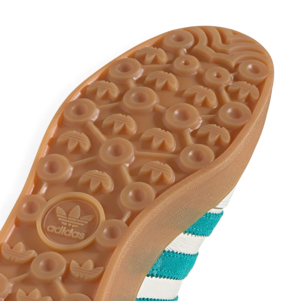 Detailed close-up angle capturing the textured sidewall profile of the gum rubber midsole meeting the branded heel edge.
