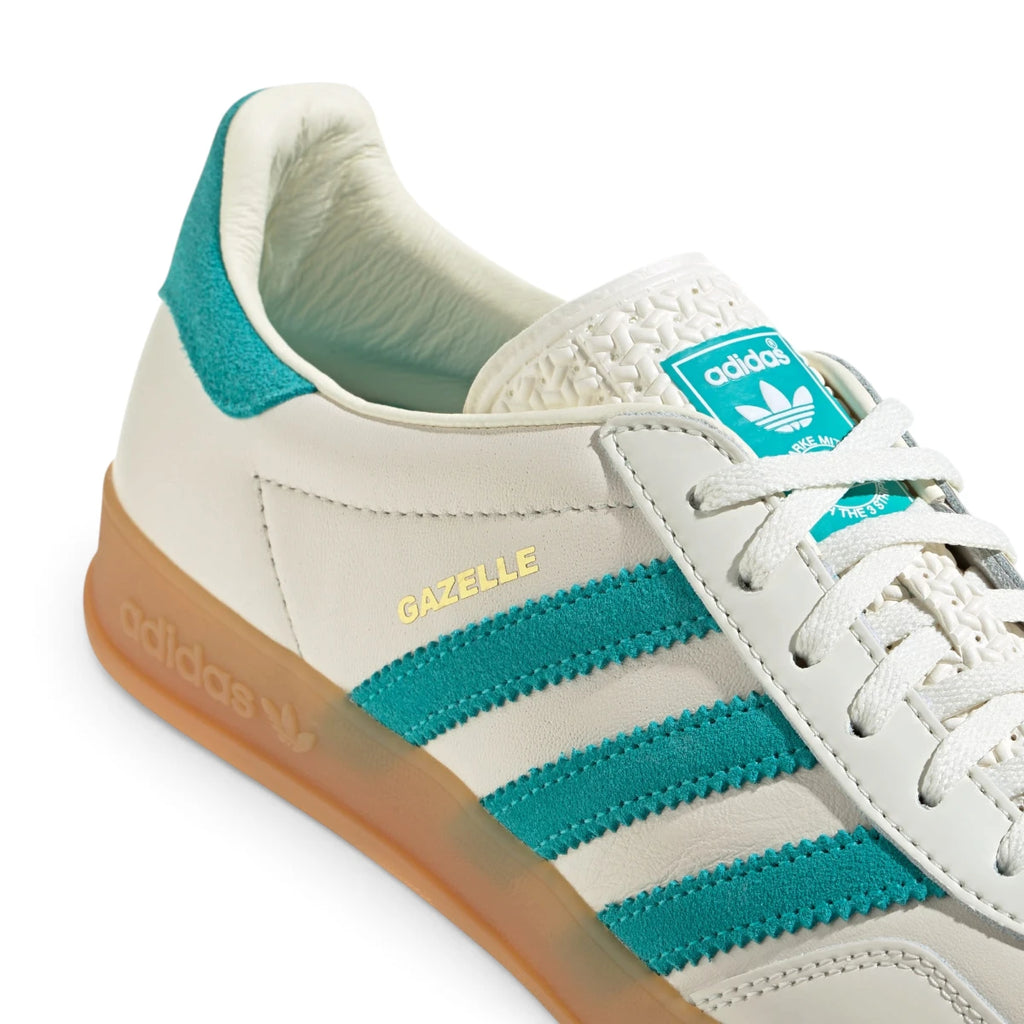 Macro focus on the smooth toe box leather, white flat laces, and the patterned white tongue construction.