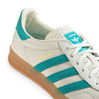 Macro focus on the smooth toe box leather, white flat laces, and the patterned white tongue construction.