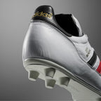 Heel: Focusing on the black heel tab with the gold metallic adidas trefoil logo.