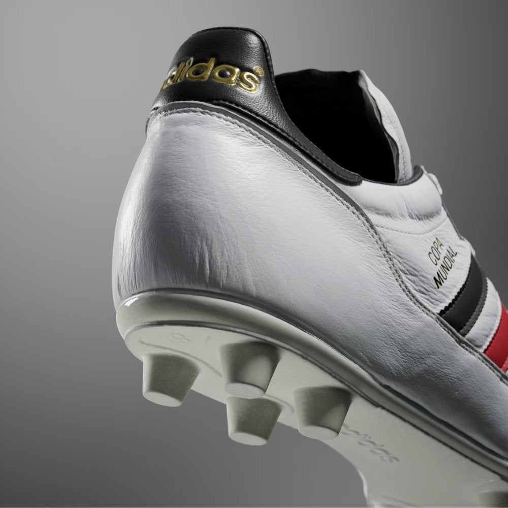 Heel: Focusing on the black heel tab with the gold metallic adidas trefoil logo.