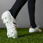 Heel: Focusing on the black heel tab with the gold metallic adidas trefoil logo.