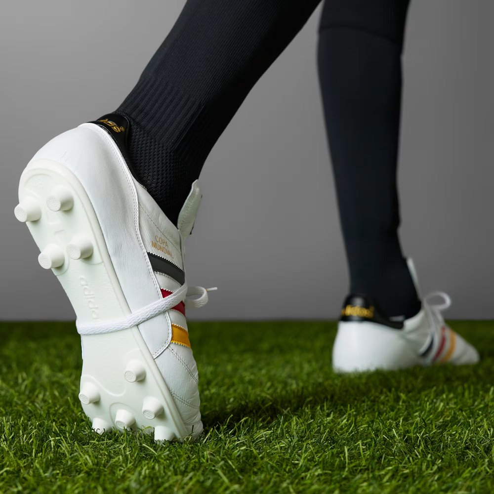 Heel: Focusing on the black heel tab with the gold metallic adidas trefoil logo.