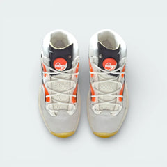 Top-down view of the "Pump Universe" trainers, highlighting the airy mesh panels, white lacing, and the functional orange Pump buttons.