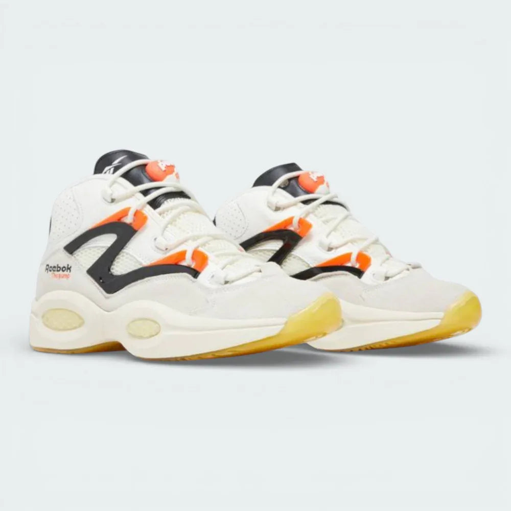 Angled shot of both Question Pump trainers side by side, showcasing the bold hybrid design and the vibrant contrast of the orange and black accents.