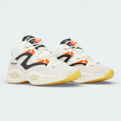 Angled shot of both Question Pump trainers side by side, showcasing the bold hybrid design and the vibrant contrast of the orange and black accents.