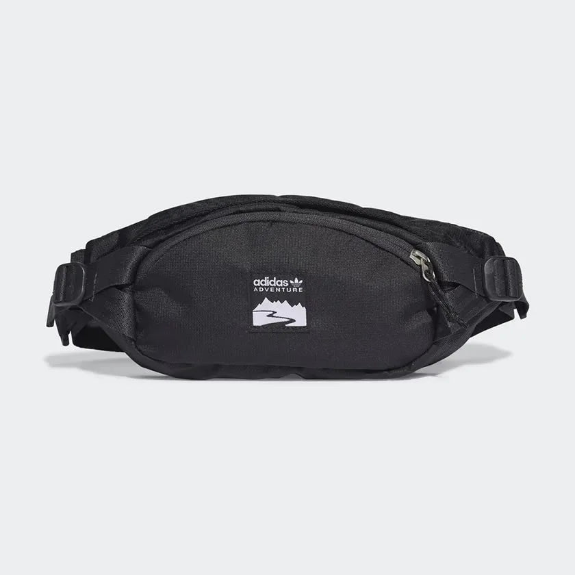 Adidas Adventure Waist Bag in black, front view showing main zip pocket, front zip pocket, and woven Adidas brand patch. Main image