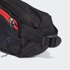 Side profile of the Adidas Adventure Waist Bag in black, highlighting its compact depth and the ripstop fabric texture.