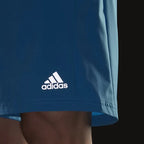 Close-up of adidas Men's Run It Running Shorts H36473 moisture-wicking fabric and logo detailing