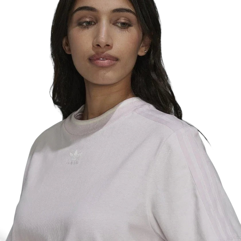 Close-up zoom on the fabric of the Adidas Tennis Luxe Tee Dress in ambient blush pink, showing the soft cotton jersey texture and any embroidered Adidas logo detail.
