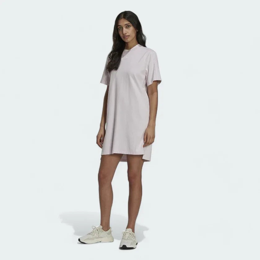 Adidas Tennis Luxe Tee Dress Women's in ambient blush pink, front view on a model, showing its relaxed, oversized fit, ribbed crew neck, and short sleeves. Main image