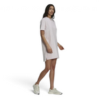 Adidas Tennis Luxe Tee Dress Women's in ambient blush pink, front view on a model, showing its relaxed, oversized fit, ribbed crew neck, and short sleeves.