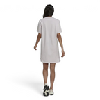 Adidas Tennis Luxe Tee Dress Women's in ambient blush pink, back view on a model, highlighting the loose drape and comfortable silhouette.