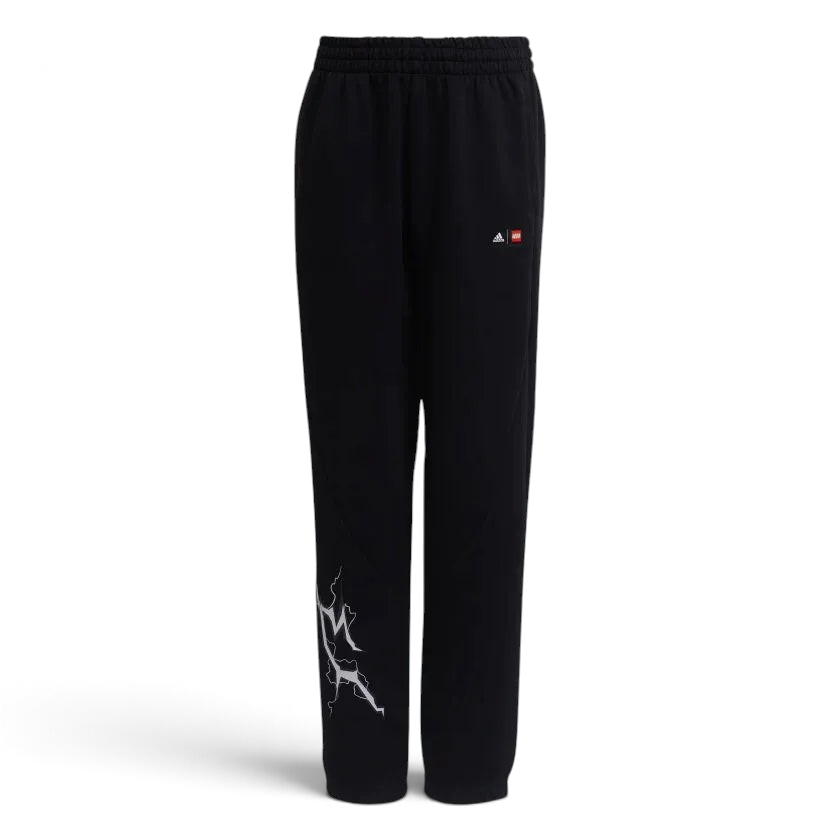 Black Adidas track pants with a white and red graphic on the left leg, featuring an elastic waistband with a drawstring and Adidas branding on the upper left.