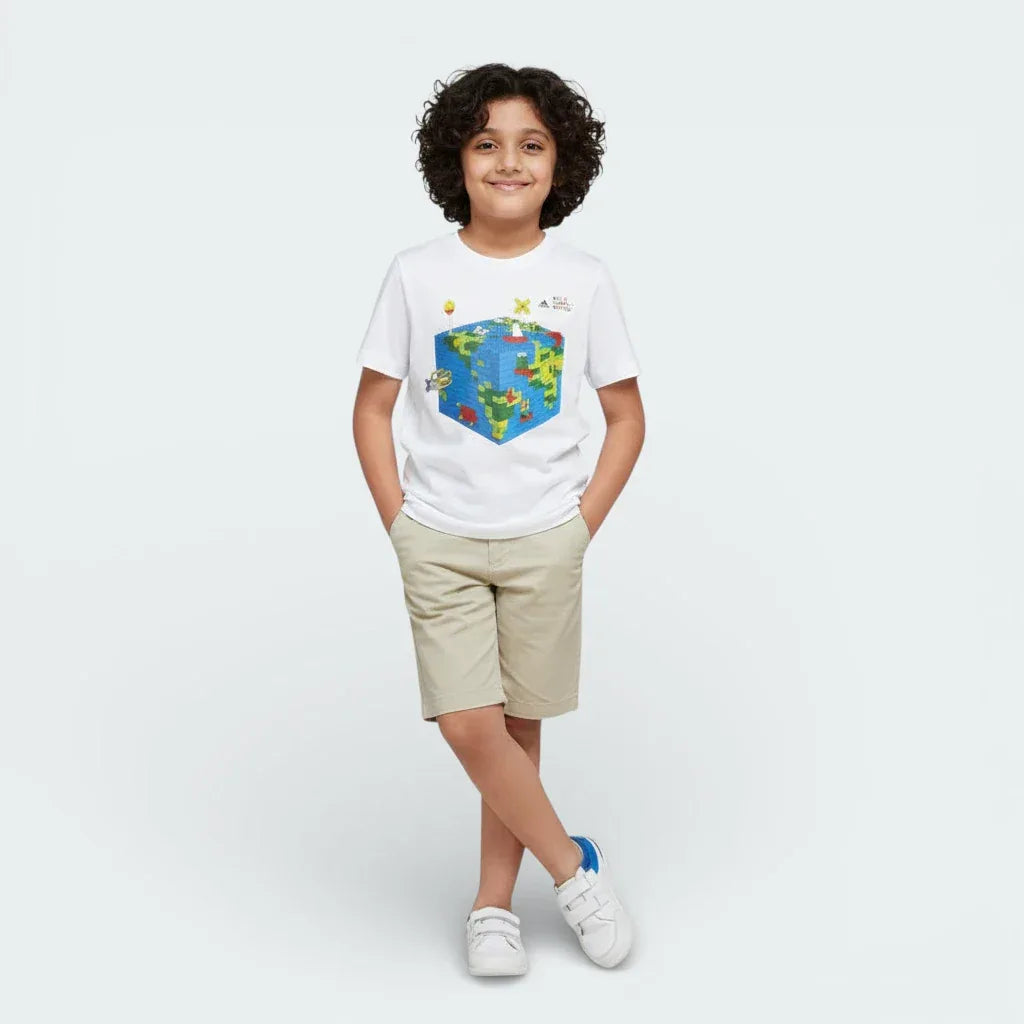 Child wearing a white t-shirt with a colorful graphic design on a plain background Main image