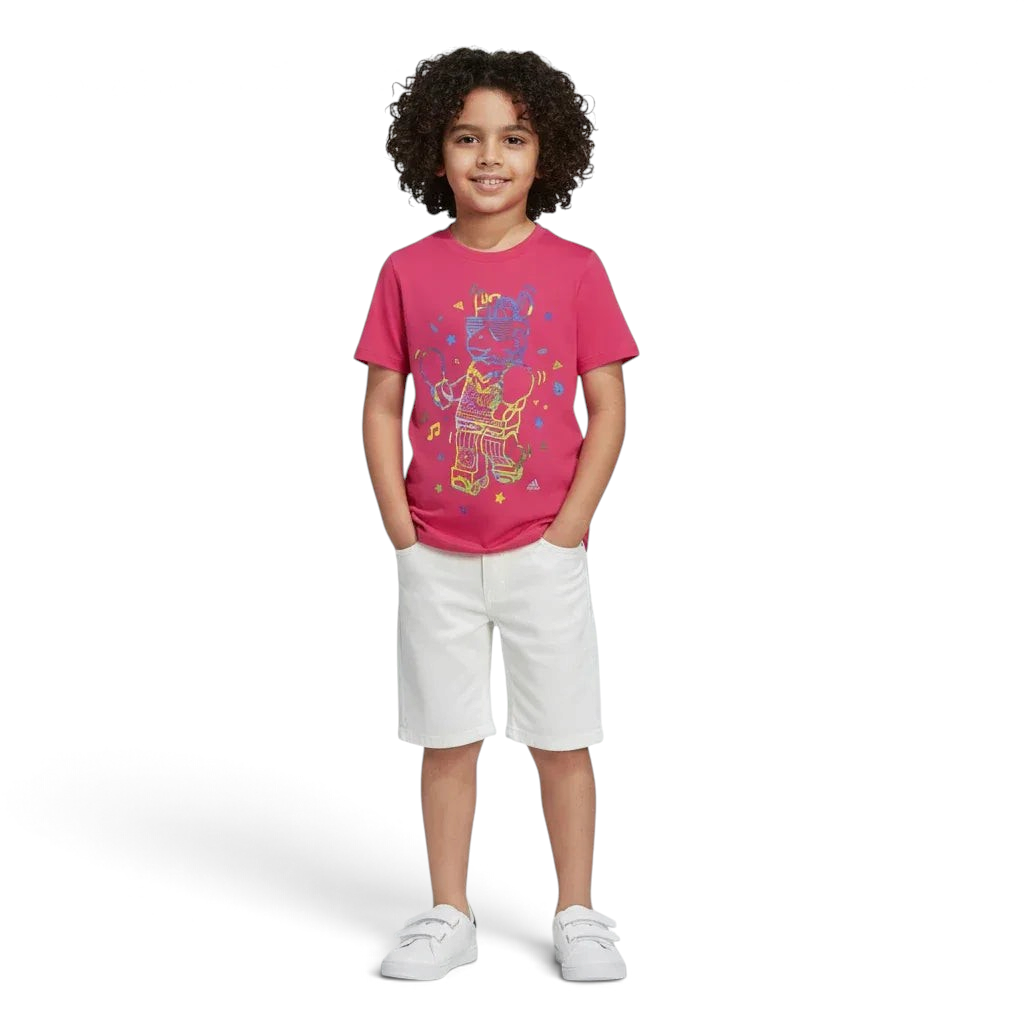 Trade Sports junior wearing a real magenta adidas x LEGO cotton graphic t-shirt with white shorts and sneakers