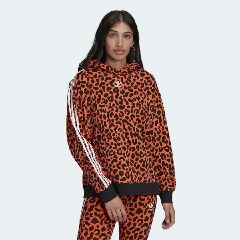 Adidas x Rich Mnisi Hoodie Women's in a true orange and black animal print, front view showing the drawcord hood and kangaroo pocket. Main image