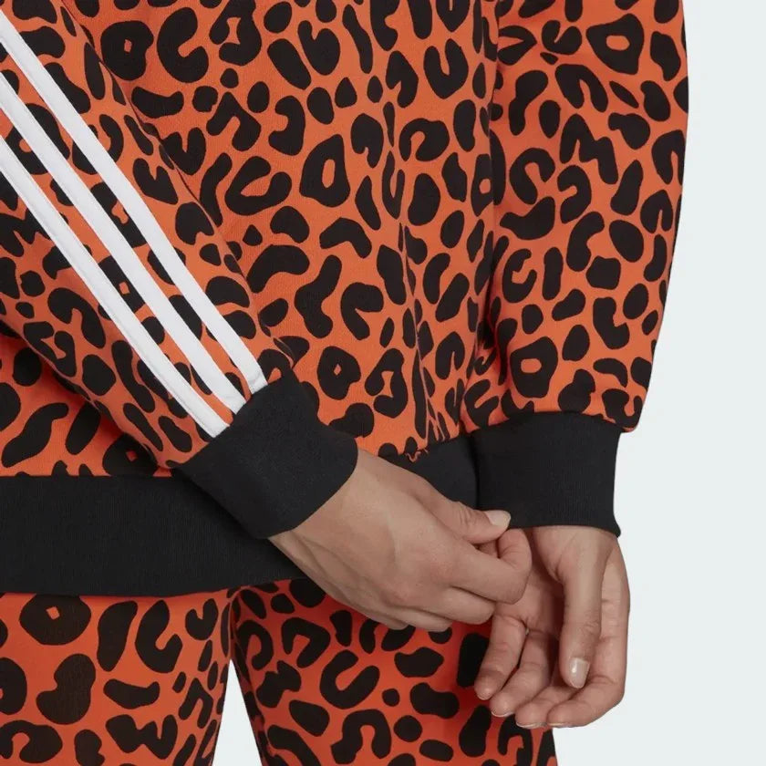 Detailed zoom on the sleeves of the Adidas x Rich Mnisi Hoodie, highlighting the adjustable fit and the all-over graphic print.
