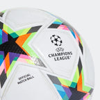 Close-up of a panel on the Adidas Champions League 2022/23 Pro Match Ball HE3777, showing the vibrant Champions league graphics and subtle star-shaped surface texture.