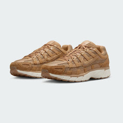 Angled view of two Nike P-6000 SE men's trainers in flax, side by side, showcasing their chunky, retro-inspired aesthetic and layered construction.