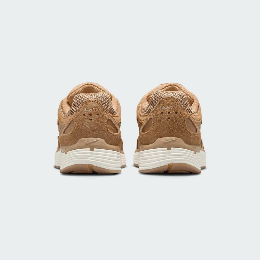 Rear view of the Nike P-6000 SE men's trainers, focusing on the heel design, layered materials, and subtle branding.