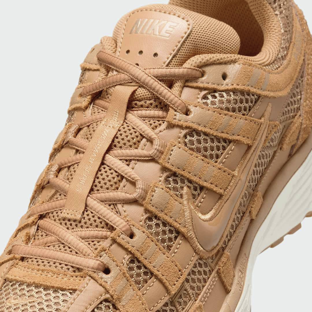 Close-up zoom on the front of the Nike P-6000 SE men's trainers, showing the intricate mesh base, layered overlays, and lacing system.