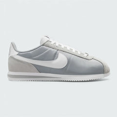 Gray sneaker with a white Nike logo on a light gray background