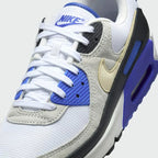 Close-up of Nike Air Max 90 Premium Men's White Trainers HF3449-100 laces, mesh and leather panel texture, and tongue label