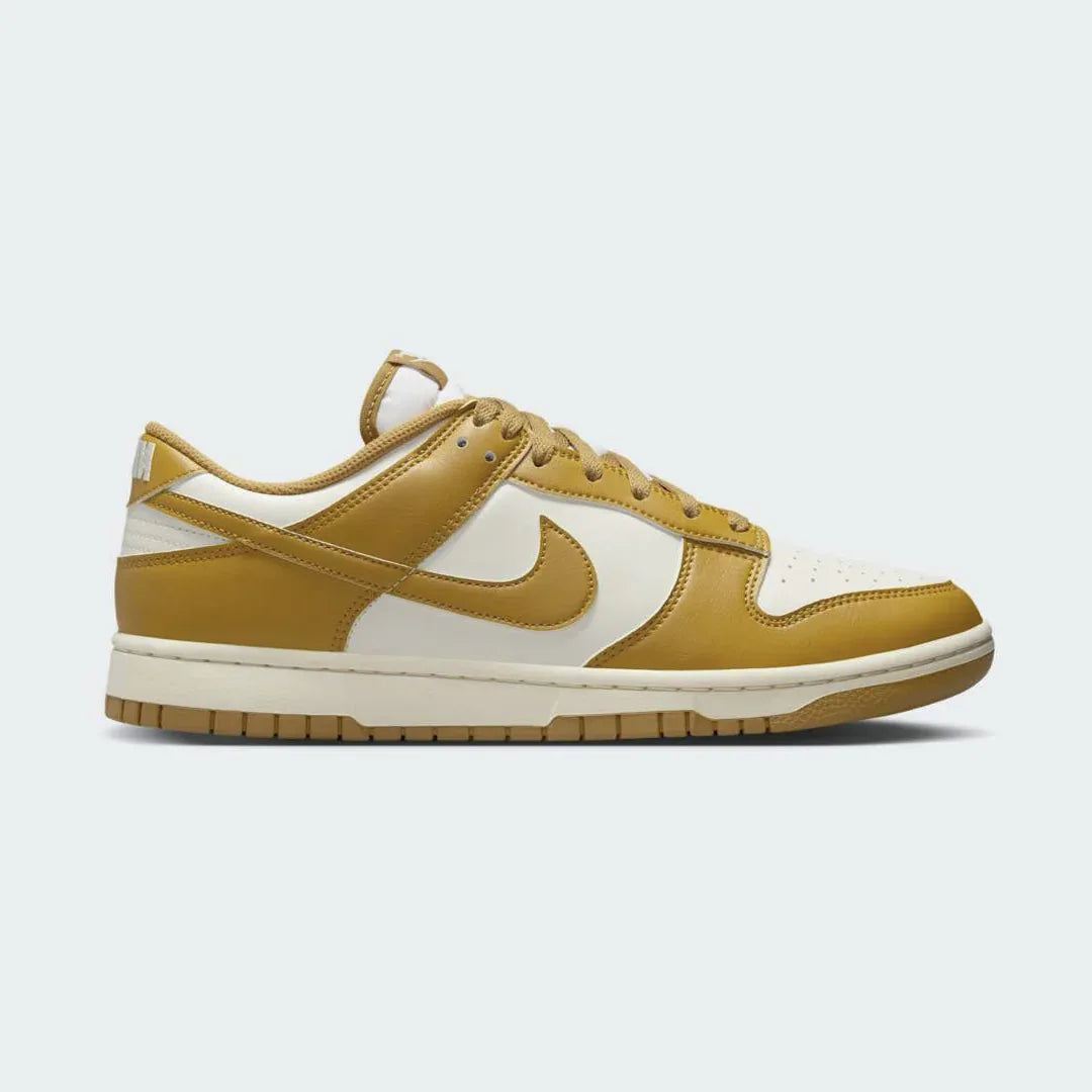 Nike Dunk Low Retro Men's trainers in wheat brown, side profile showing classic leather upper, black Swoosh, and white midsole. Main image