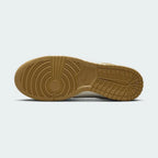 View of the outsole of the Nike Dunk Low Retro Men's wheat trainers, showing the durable rubber sole and pivot circles for traction.