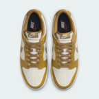 Top-down view of a pair of Nike Dunk Low Retro Men's trainers in wheat, highlighting their iconic silhouette and lace-up closure.