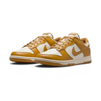 Angled view of two Nike Dunk Low Retro Men's wheat trainers, side by side, showcasing their timeless design and classic athletic aesthetic.