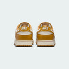 Rear view of the Nike Dunk Low Retro Men's wheat trainers, focusing on the contrasting black heel tab with white Nike branding.