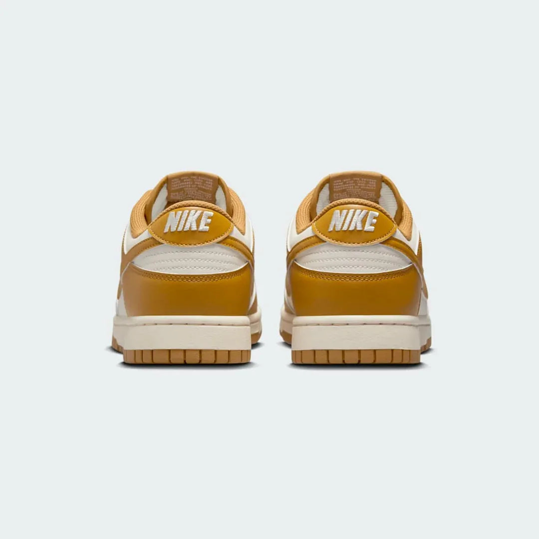 Rear view of the Nike Dunk Low Retro Men's wheat trainers, focusing on the contrasting black heel tab with white Nike branding.