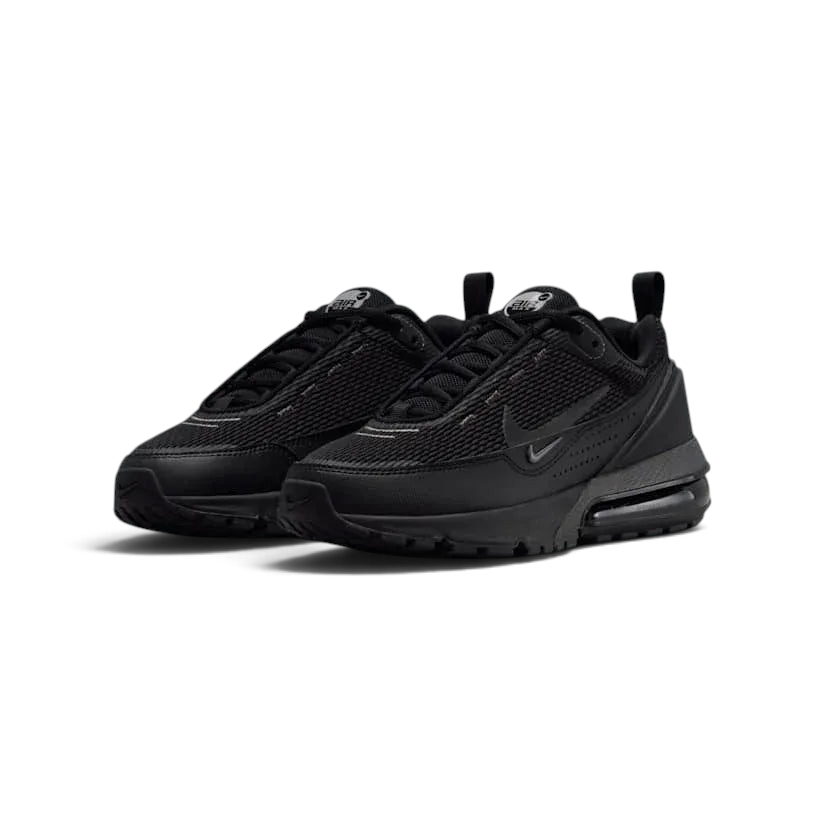 Angled view of two Nike Air Max Pulse Juniors' trainers in black and grey, side by side, showcasing their bold design and visible Air unit.
