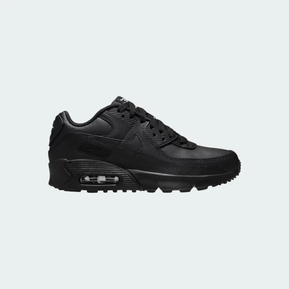 Nike Air Max 90 Juniors' trainers in all black with a white midsole accent, side profile showing visible Max Air unit and classic layered design. Main image