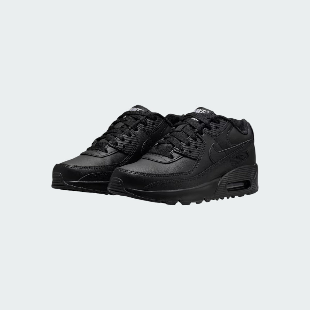 Angled view of two Nike Air Max 90 Juniors' black trainers, side by side, showcasing their timeless aesthetic and clean, dark colourway.