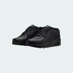 Angled view of two Nike Air Max 90 Juniors' black trainers, side by side, showcasing their timeless aesthetic and clean, dark colourway.